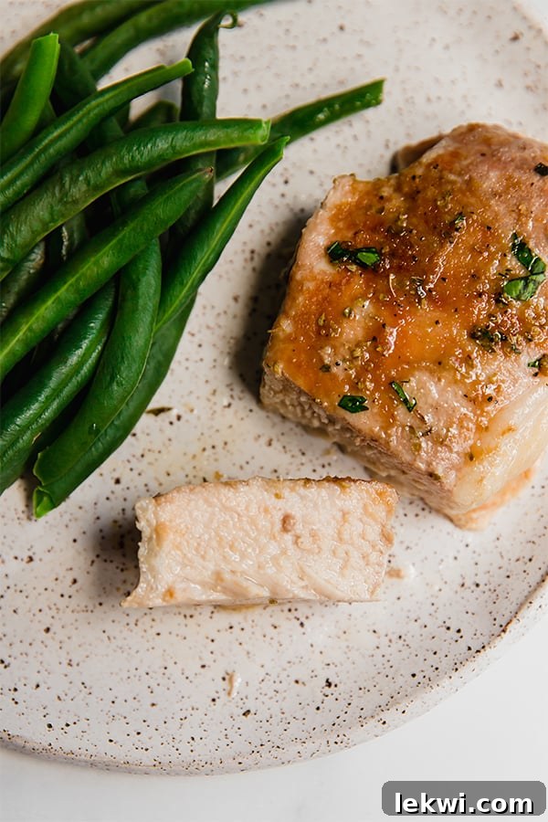 Slice of pork chop on a plate.