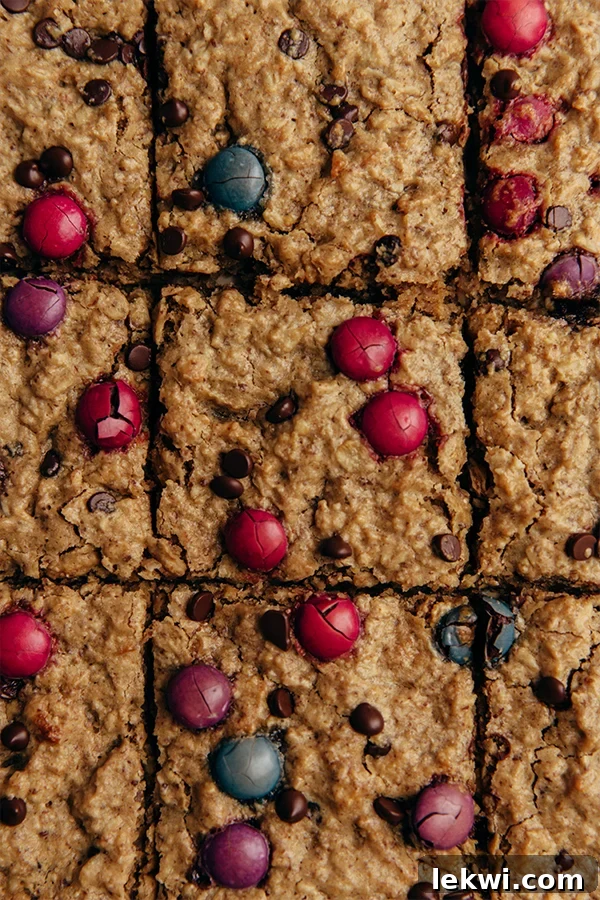 Colorful Monster Cookie Oatmeal Breakfast Bars cut into neat squares, showcasing their chewy texture and fun mix-ins.