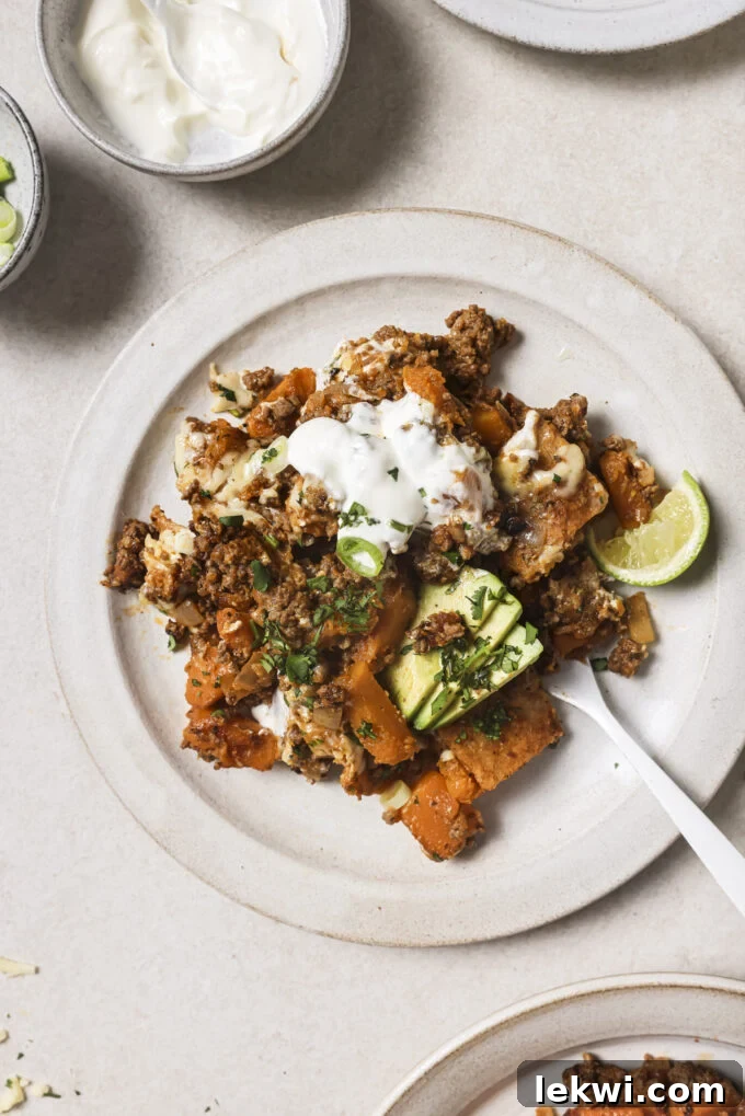 Ground beef enchilada skillet on a plate with a fork.
