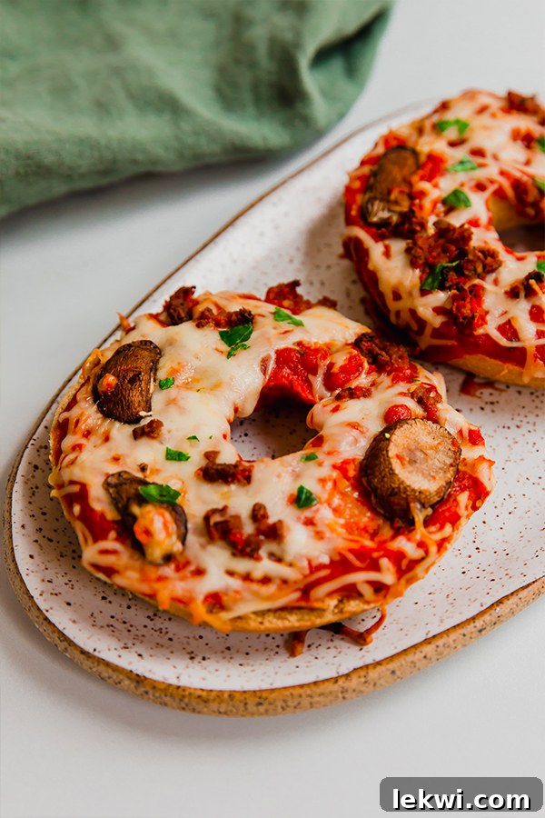 Gluten-free pizza bagels on a plate, ready to eat.