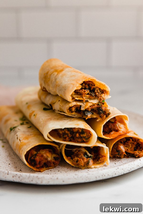 Gluten-free pizza roll ups stacked on a plate.