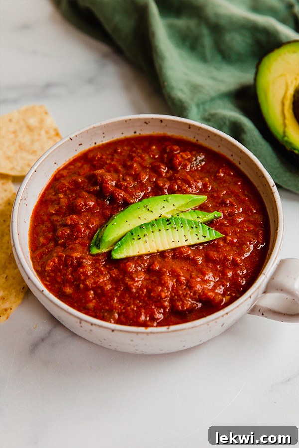 Chili topped with fresh avocado slices.