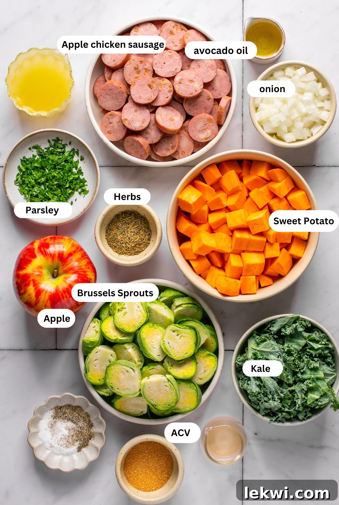 Separated ingredients for Apple Chicken Sausage Skillet in various bowls.