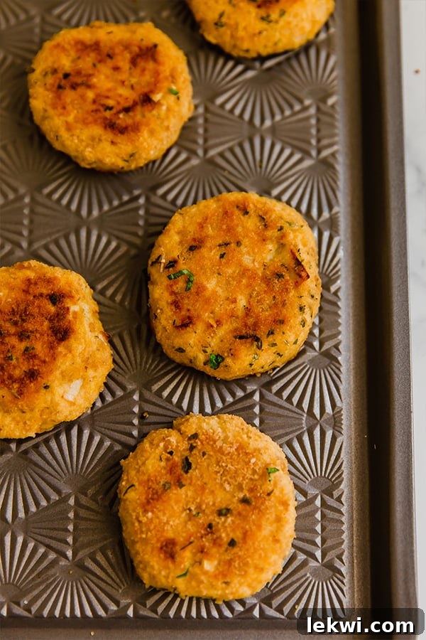 Butternut salmon cakes on a baking sheet.