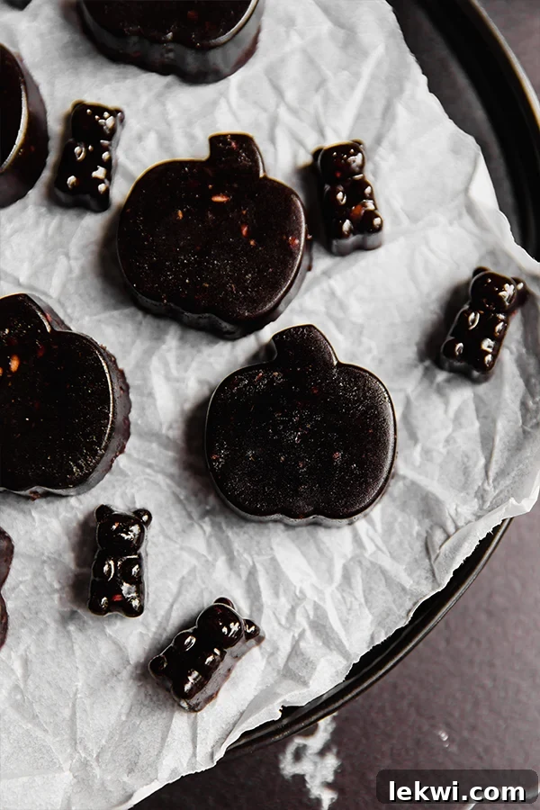 Black Halloween gummies on a lined dish.