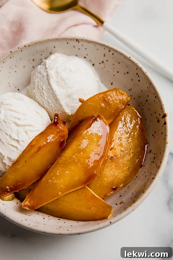 A bowl of caramelized pears with ice cream.