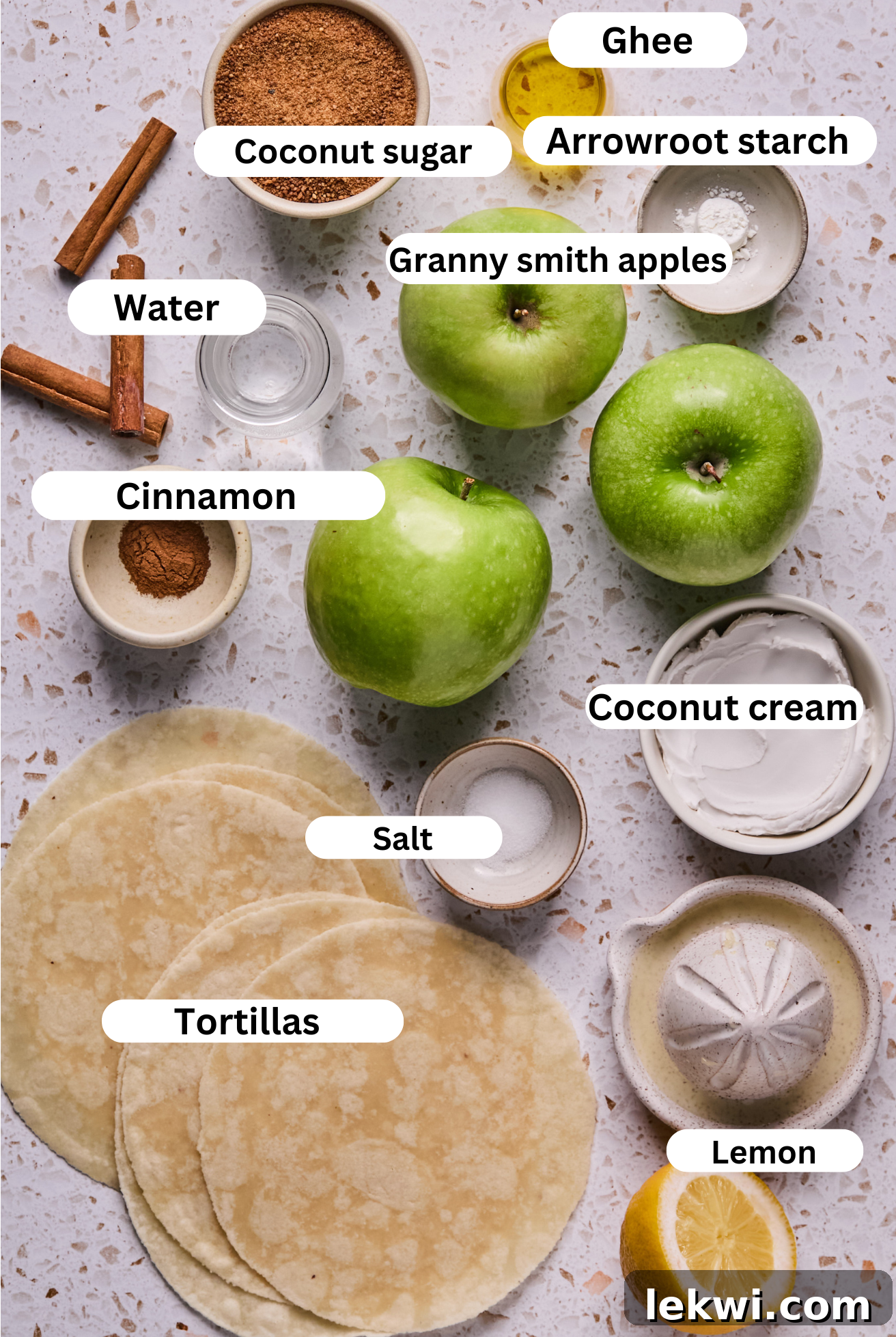 Individual bowls displaying the core ingredients for Apple Pie Roll-Ups: chopped apples, ground cinnamon, and creamy ghee.