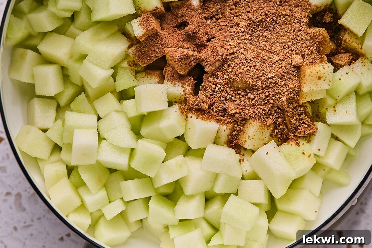Chopped apple and coconut sugar, ready to be mixed and cooked in a pot.