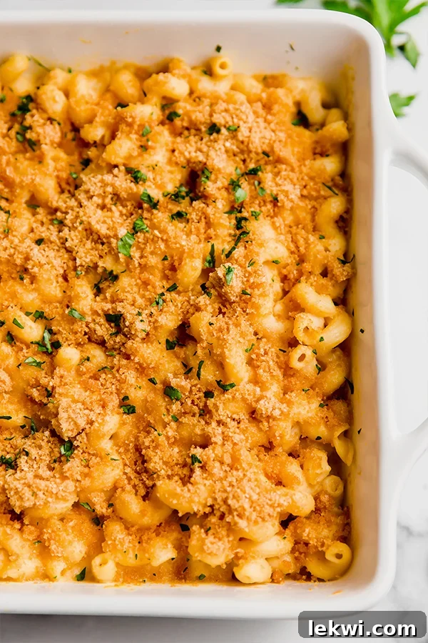 Paleo mac and cheese in a baking dish, showcasing its creamy texture and crispy topping.