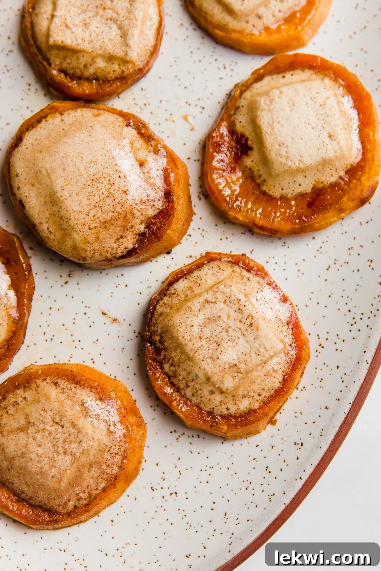 Sweet potato casserole bites with melted marshmallows on a plate.