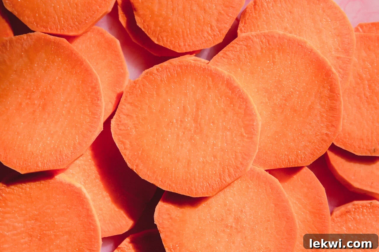 Sliced sweet potato rounds on a cutting board.