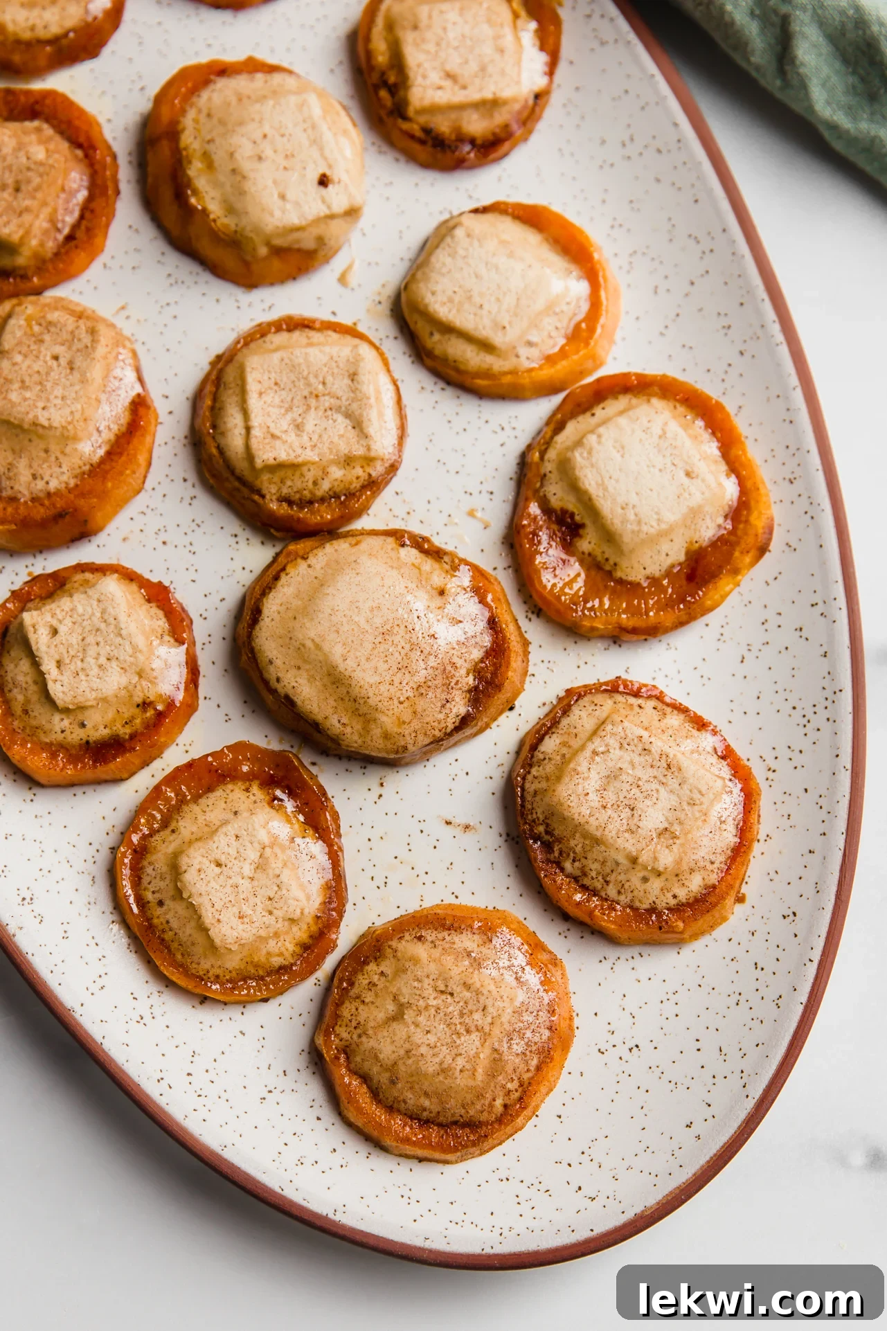 Sweet potato casserole bites with melted marshmallows on a large platter.