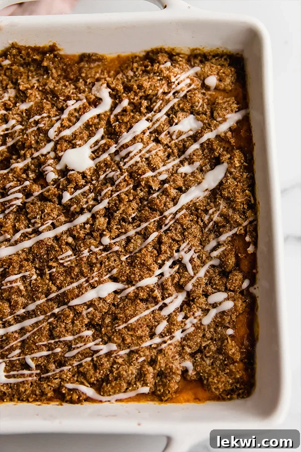 Baking dish of sweet potato casserole with streusel topping.