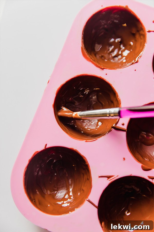 hot cocoa bomb mold filled with chocolate
