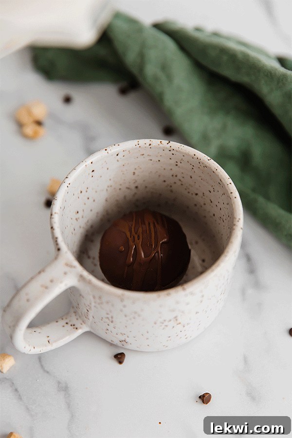 Gif of hot milk pouring over a hot cocoa bomb.