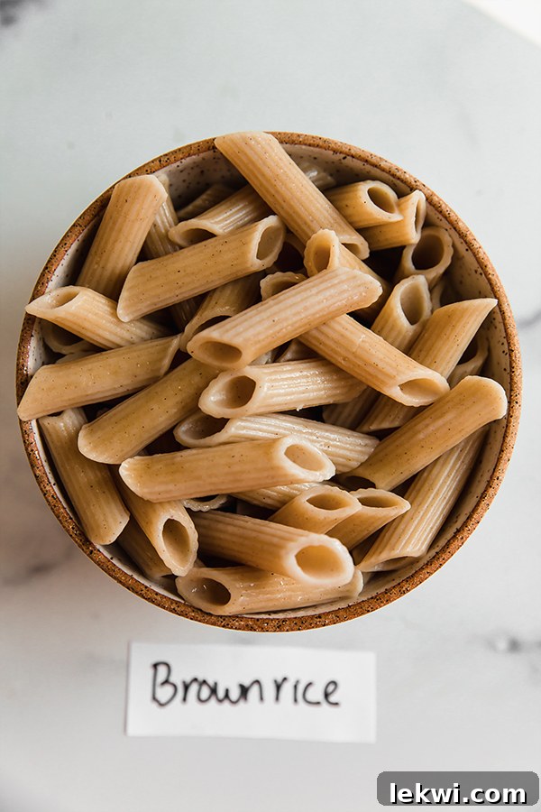 A bowl of cooked Jovial brown rice pasta, showcasing its familiar texture and golden-brown hue.
