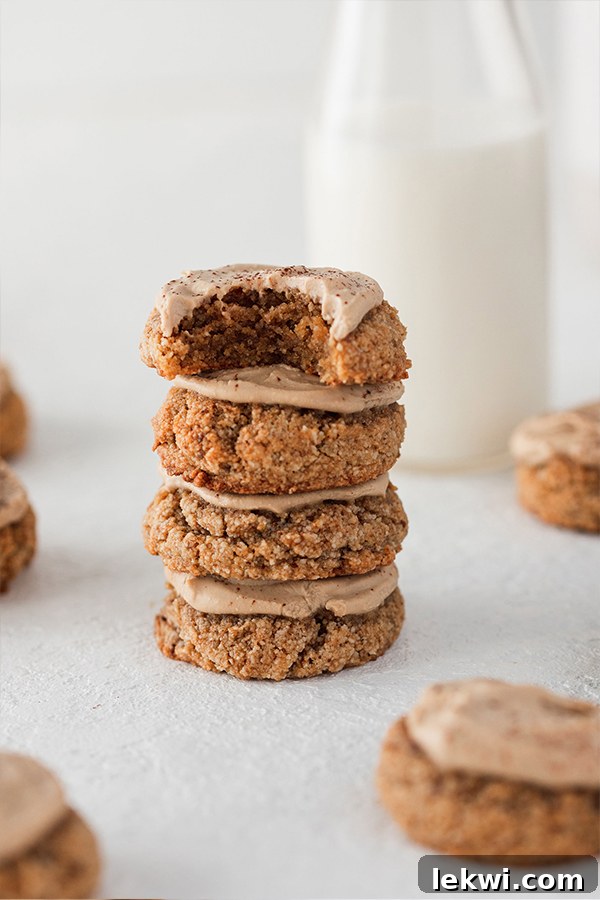 A neatly stacked tower of three tiramisu cookies, showing their texture and creamy topping.