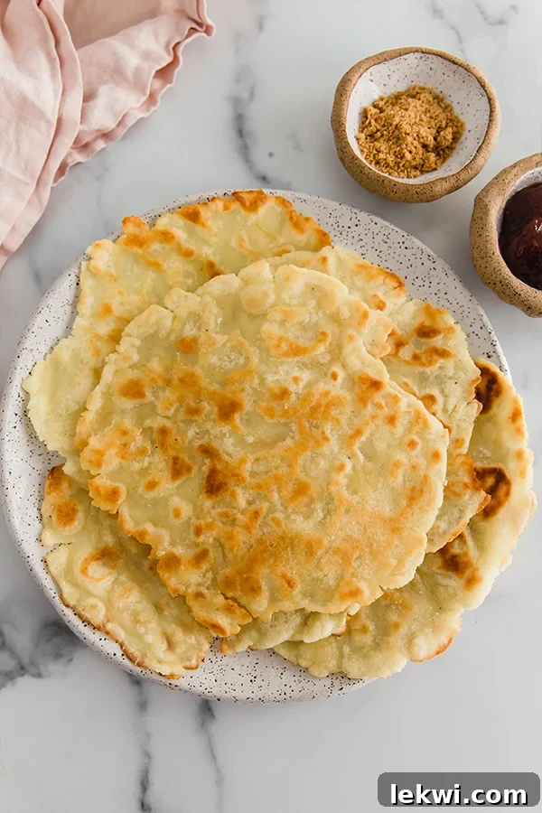 A stack of freshly cooked, folded Norwegian Lefse, ready to be served.