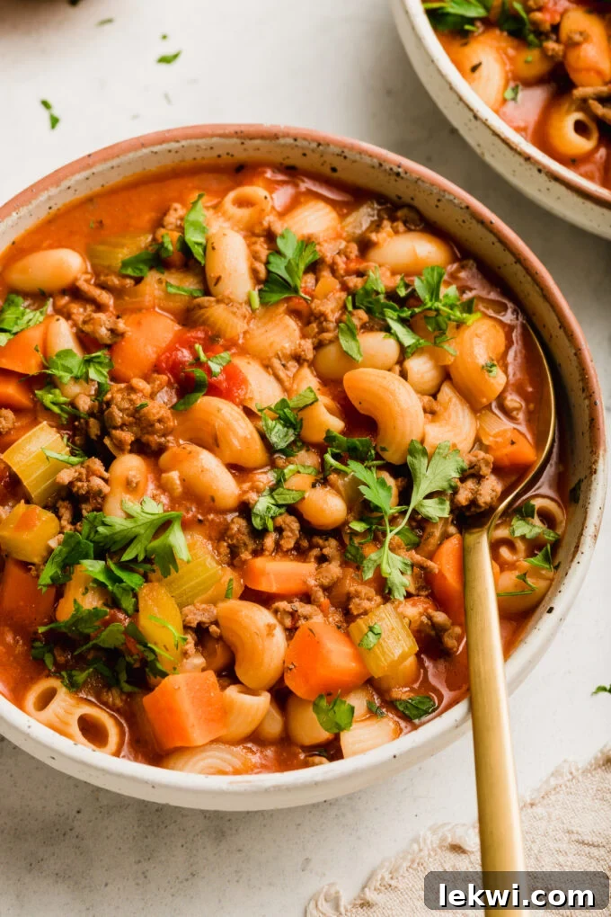A close-up of a steaming bowl of gluten-free Pasta Fagioli soup, ready to be enjoyed.