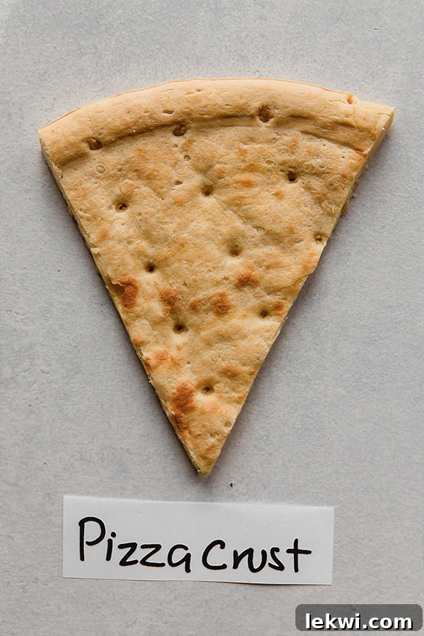 A delicious chickpea flour pizza crust, lightly topped and ready for baking, showcasing its substantial texture.