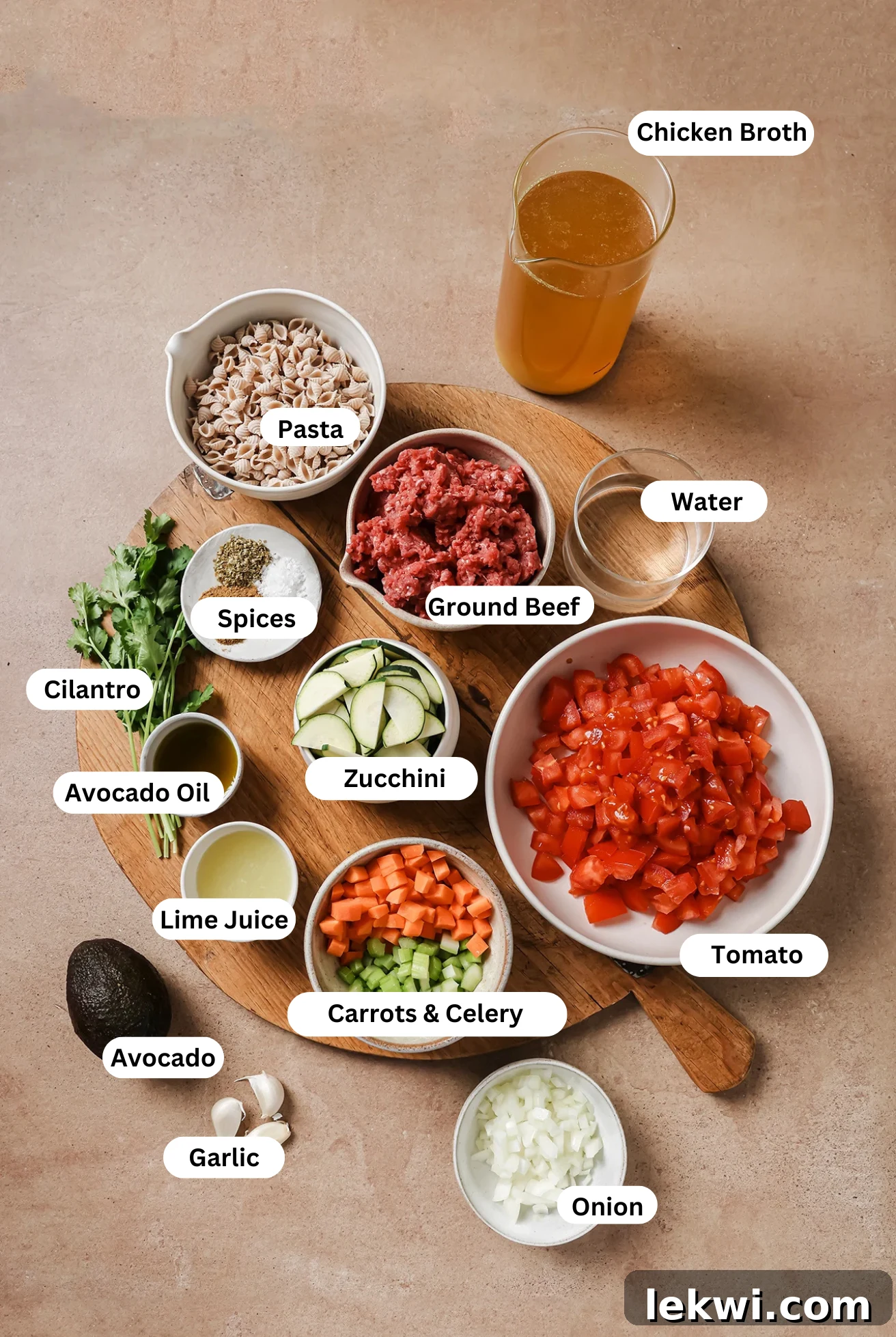 Key ingredients for Conchitas con Carne, including fresh zucchini, bright lime juice, and healthy avocado oil, laid out on a clean surface.