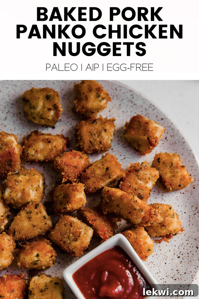 Food with text "Baked Pork Panko Chicken Nuggets Paleo | AIP | Egg-Free." showcasing the delicious appearance of the nuggets.