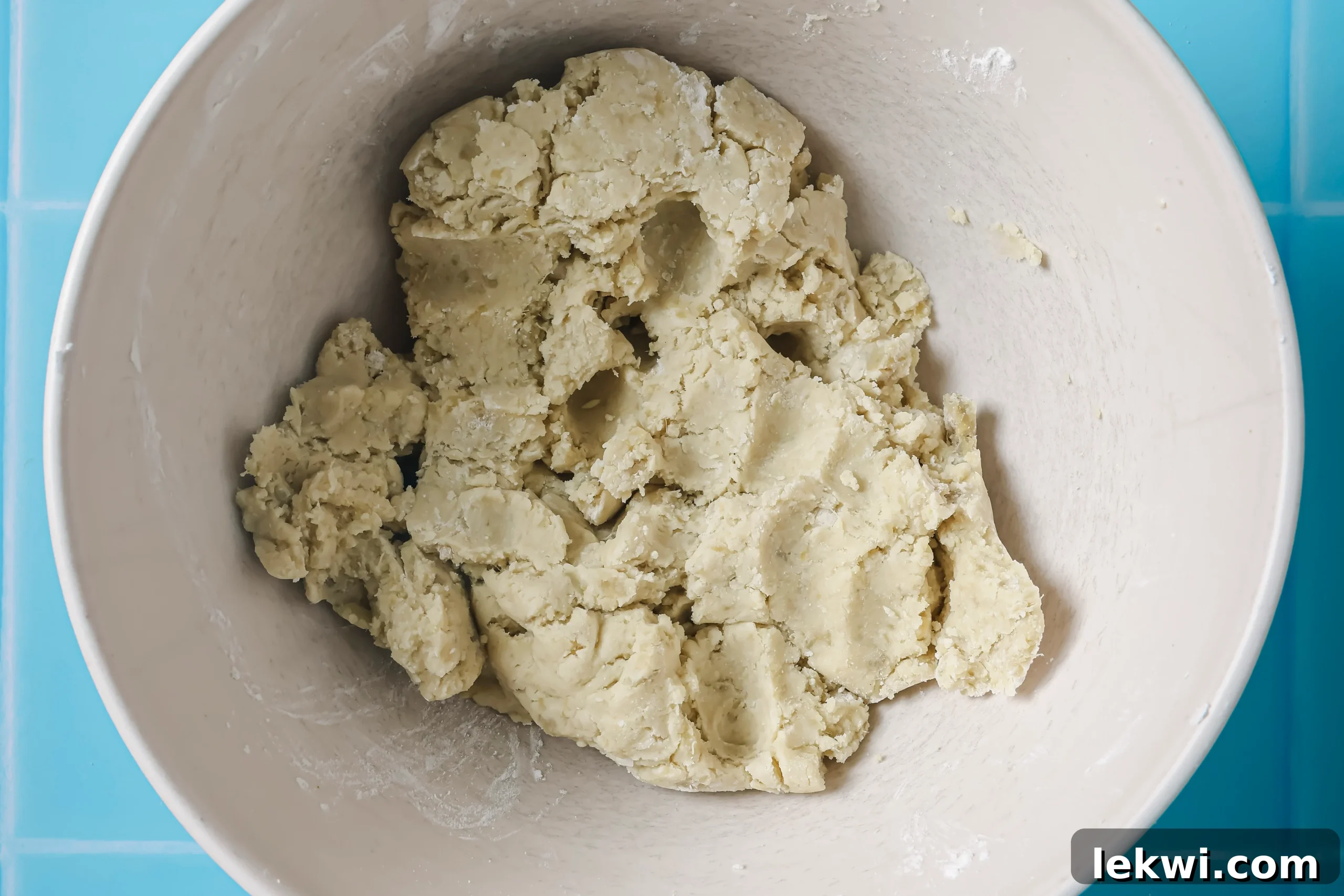 Sweet potato smiley fries ingredients mixed together in a bowl, forming a pliable dough ready for shaping.