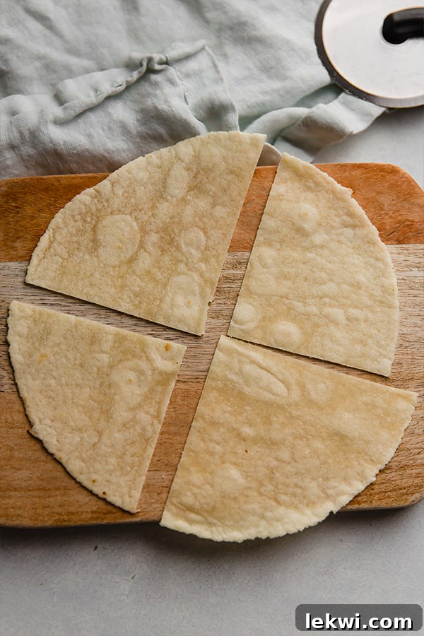 An almond flour tortilla perfectly sliced into four large triangular pieces, ready for the air fryer.