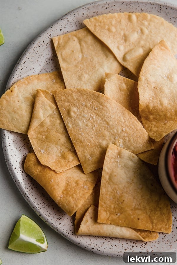A beautifully arranged plate showcasing a generous serving of crispy almond flour tortilla chips, invitingly golden and ready to be enjoyed.