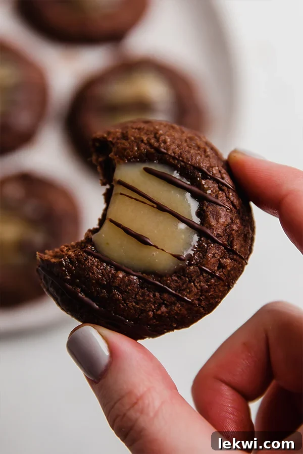 Holding a copycat adventureful with a bite taken out.