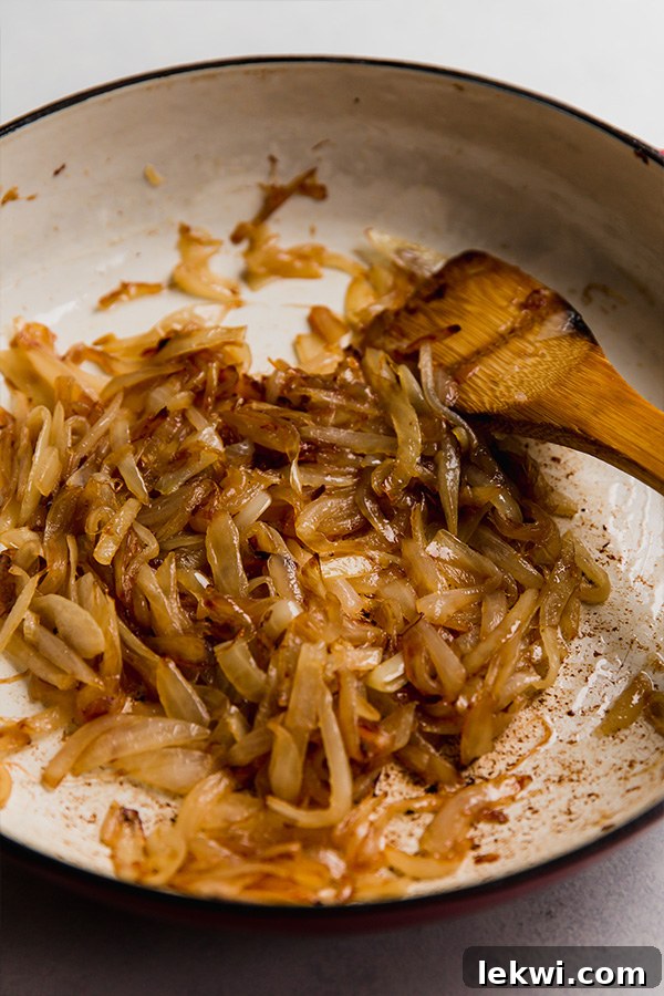 Close-up of golden brown caramelized onions in a cast iron skillet.