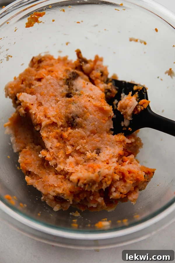 The savory mixture for turkey breakfast sausages in a glass mixing bowl, ready to be formed.