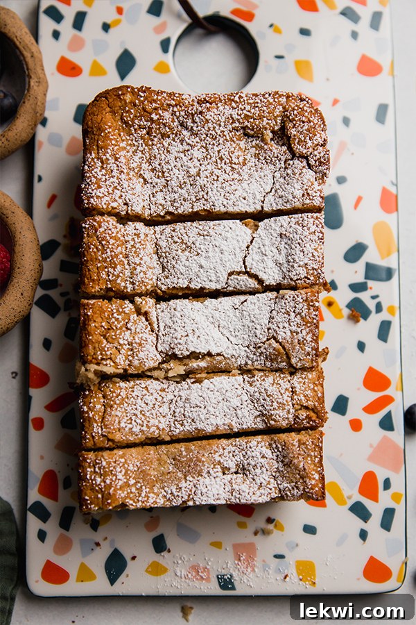A beautifully cut loaf of paleo applesauce pound cake, showing its moist and tender interior.