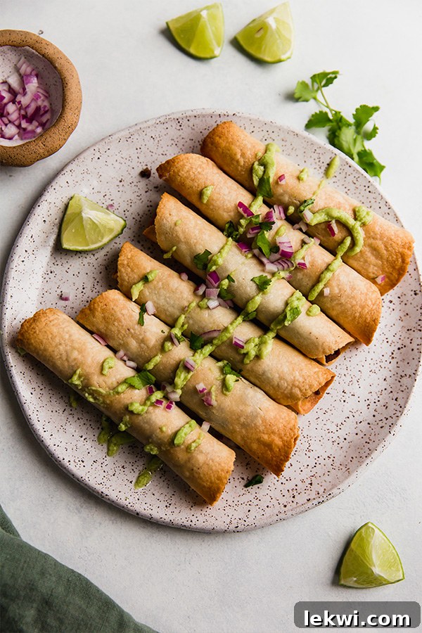A tempting plate showcasing several perfectly baked sweet potato and beef breakfast taquitos, ready to be enjoyed.