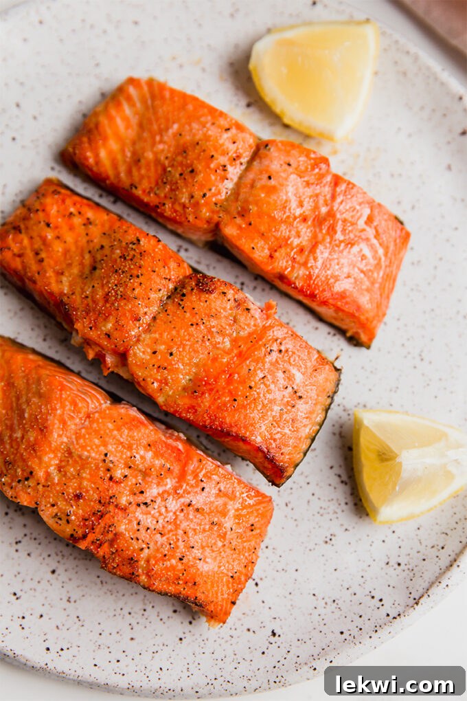 A plate with air fryer salmon filets sitting on it, ready to be served.