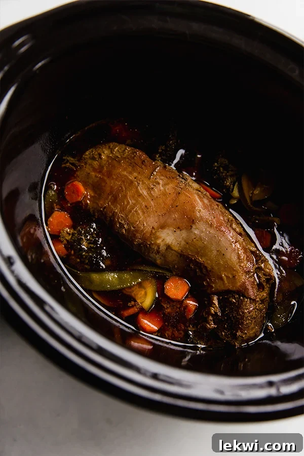 The meal in the slow cooker, ready to be served. Succulent pork and tender vegetables.
