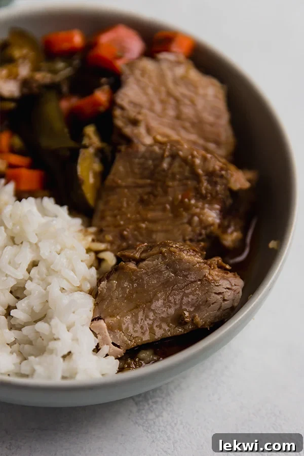 Teriyaki pork tenderloin and vegetables in a dish with rice. A complete, healthy meal.