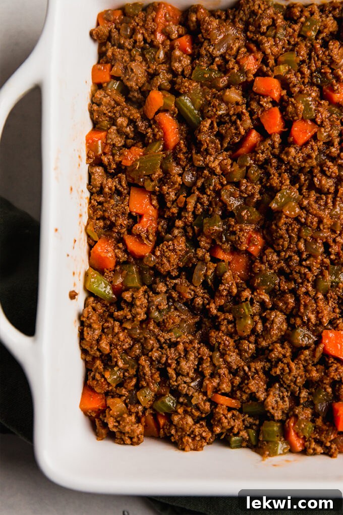 The sweet potato topping spread over the meat and vegetable filling in the baking dish before baking.