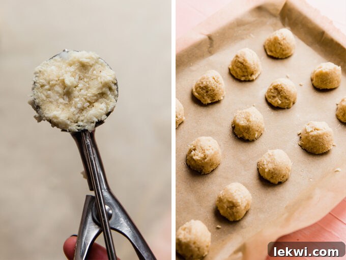 Rows of scooped coconut macaroon dough neatly arranged on a parchment-lined baking sheet, ready for the oven.