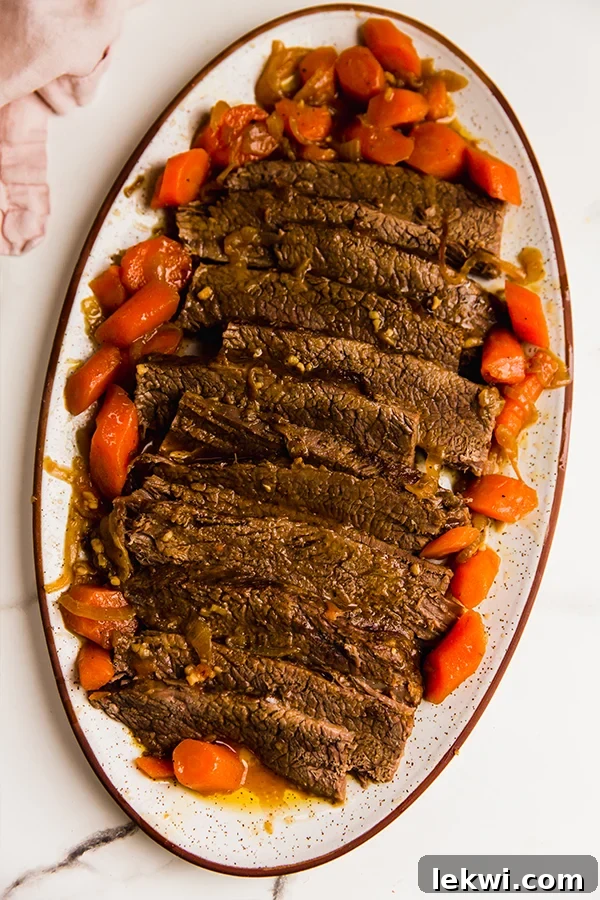 Brisket on a platter with vegetables.