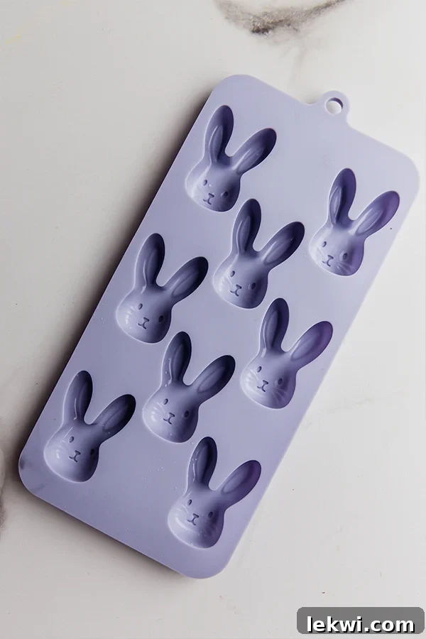 A collection of silicone molds specifically designed for creating charming chocolate Easter bunnies, neatly arranged and ready for use in making homemade dairy-free treats.