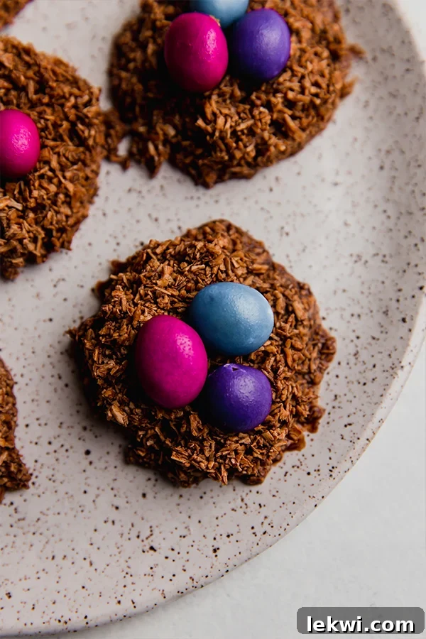 Delicious Chocolate Coconut Easter Egg Nests artfully arranged on a white plate, ready to be enjoyed.