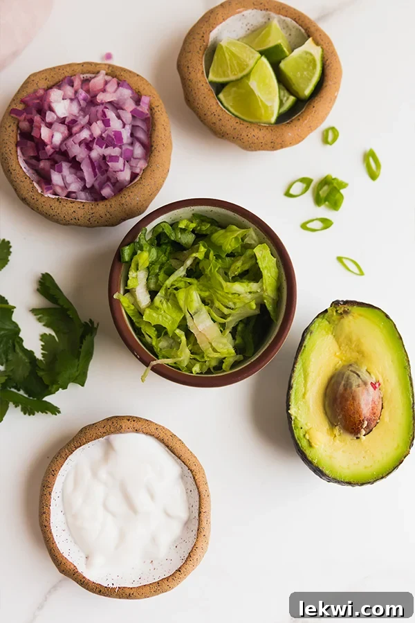 A vibrant display of all the fresh ingredients needed for making mini taco cups.