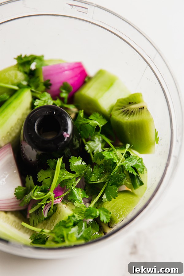 All the prepped ingredients for Nightshade-Free Salsa Verde being added into a food processor for blending.