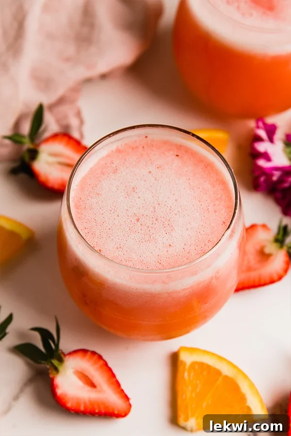 Glass of strawberry mimosa mocktail, looking fresh and inviting.