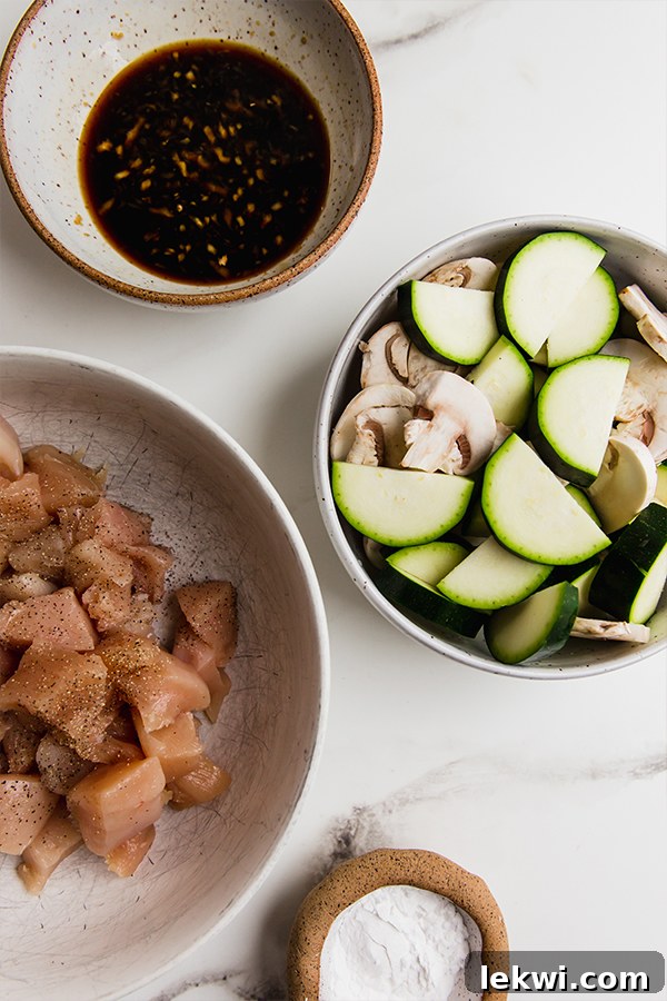 All the fresh ingredients laid out for making the mushroom chicken stir fry at home.
