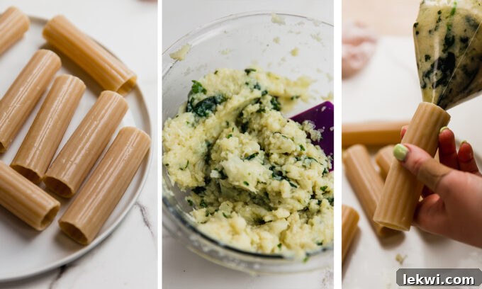 A hands-on shot demonstrating how to carefully stuff the cooked gluten-free manicotti shells with the creamy cauliflower filling.