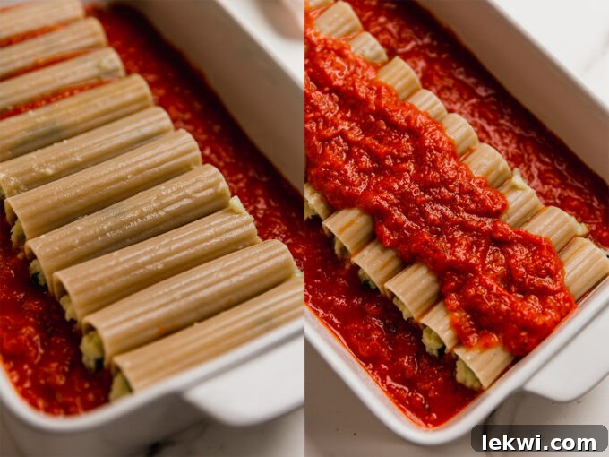 Gluten-free cauliflower manicotti shells, neatly stuffed and arranged in a baking dish, ready to be covered with marinara sauce before baking.