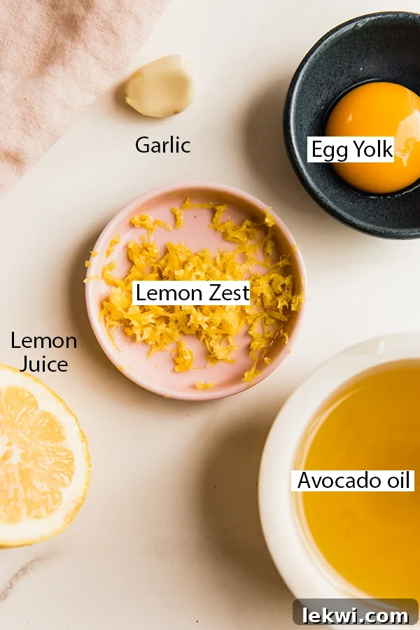 A collection of ingredients for lemon aioli, including oils, garlic, eggs, and fresh lemons, neatly arranged.