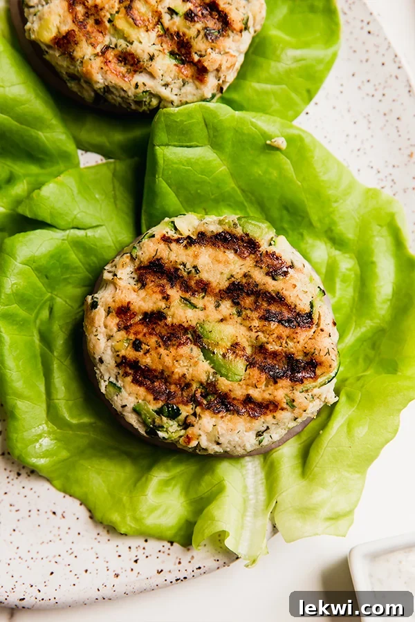 Avocado ranch and zucchini chicken burger over lettuce.